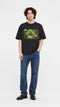 Model wearing HUGFAB black comic graphic oversized T-shirt with blue jeans on white background