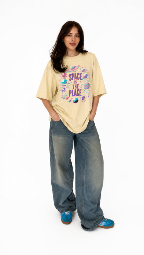 HUGFAB unisex cream oversized graphic t-shirt with colorful Space Is The Place front print, styled with baggy jeans for Gen-Z streetwear fashion