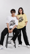 HUGFAB Rage Era oversized graphic T-shirt in white and pastel yellow worn by male and female models in streetwear style