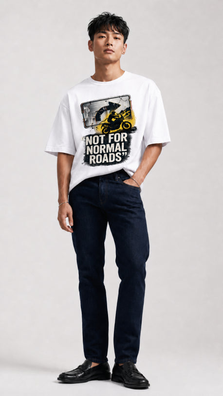 Model wearing HUGFAB white normal roads graphic oversized T-shirt with dark jeans on white background