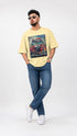 Model wearing HUGFAB yellow car graphic oversized T-shirt with blue jeans on white background